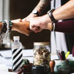 people fist bumping when succesfully hiring talent